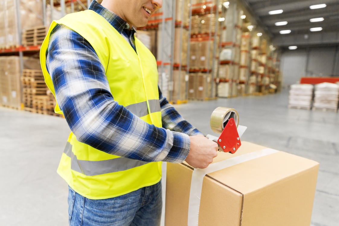 Warehouse Worker Packing Parcel