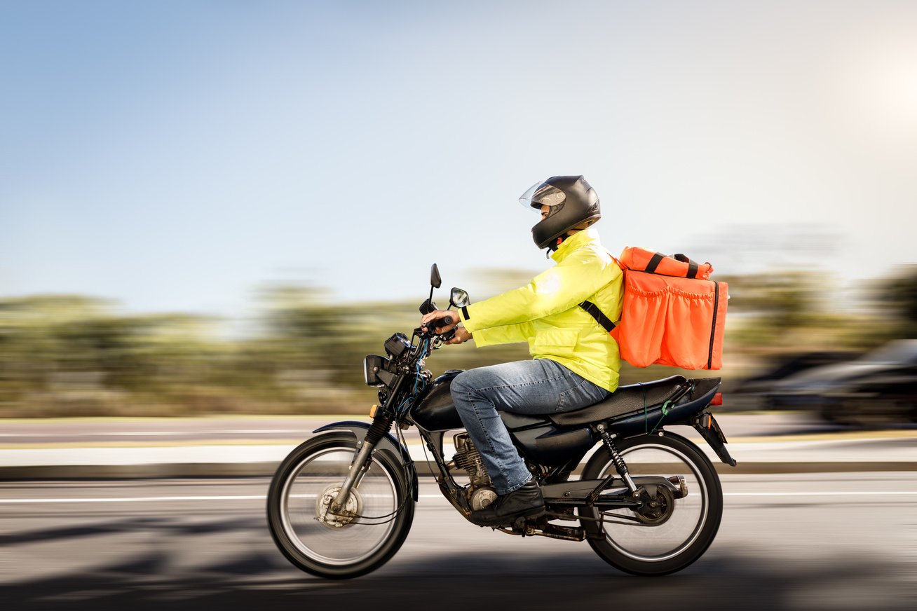 Delivery man riding a motorcycle - motoboy