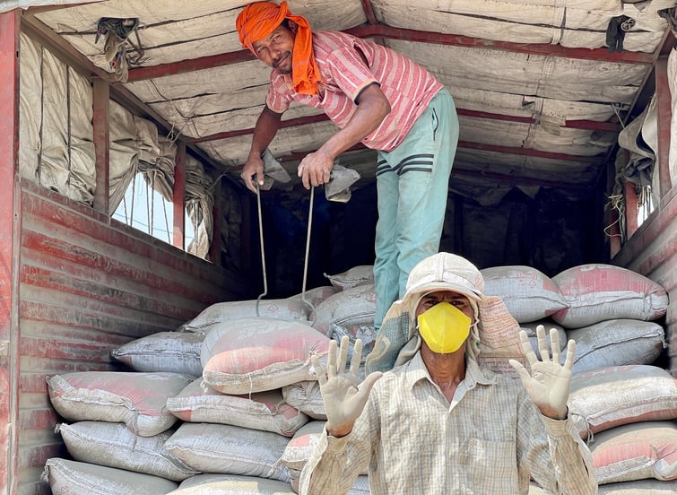 Men Unloading Bags from Truck